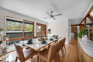a dining room with a table and chairs at Blenheim Beach Retreat in Vincentia