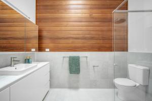 a bathroom with a toilet and a sink at Blenheim Beach Retreat in Vincentia +22 photos