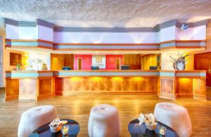 a large room with chairs and a bar at Leonardo Hotel Heidelberg Walldorf in Walldorf