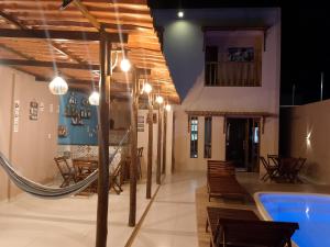 a room with a pool and a table and chairs at Casa completa in Marechal Deodoro +10 photos