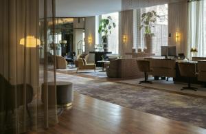 a lobby with a waiting area with chairs and desks at Hotel Mannheimer Hof - Leonardo Limited Edition in Mannheim