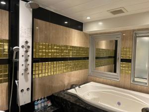 a large bathroom with a tub and a mirror at HOTEL PAL Otsuka -Adult Only- in Tokyo +55 photos