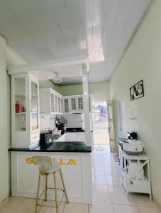 a kitchen with a counter and chairs in a room at Homestay Gavilla Dieng in Diyeng +9 photos