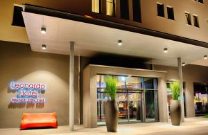 a hotel with two potted plants in front of a building at Leonardo Hotel Munich City East in Munich