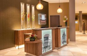 a lobby with a display case with a picture of a building at Leonardo Hotel Bad Kreuznach in Bad Kreuznach +53 photos