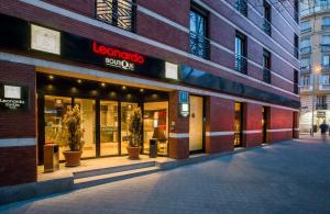 a store front of a building with potted plants outside at Leonardo Boutique Hotel Madrid in Madrid