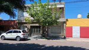 a white car parked in front of a building at Ayala Planta Alta in Santa Rosa