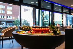 a plate of food on a table in a restaurant at NYX Hotel Hamburg by Leonardo Hotels in Hamburg