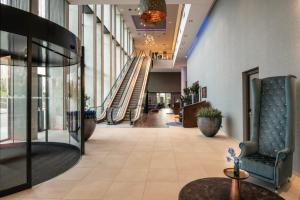 a hallway with an escalator in a building at Leonardo Royal Hotel Amsterdam in Amsterdam