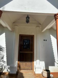 a front door of a house with a light at Casa amueblada in Jinotepe +1 photo