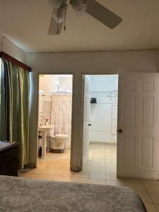 a bedroom with a bed and a bathroom with a toilet at Casa amueblada in Jinotepe