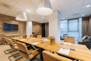 a conference room with a large table and chairs at Leonardo Hotel Groningen Stadspark in Groningen