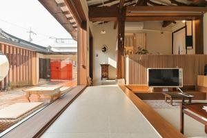 an open living room with a tv and a couch at Stay Yeojin Yeomong in Gyeongju