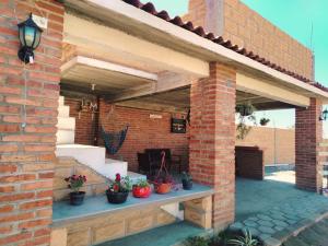 a brick building with potted plants on a patio at La Casa de Lu cerca de Volcanic park in San Martín Ojo de Agua