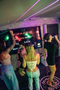 a group of people in a room brushing their teeth at Aslan Boutique Apartments in Patong Beach