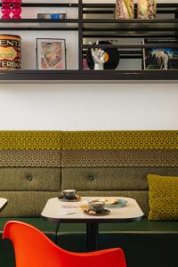 a table with a plate of food on it at Leonardo Hotel Rotterdam Savoy in Rotterdam
