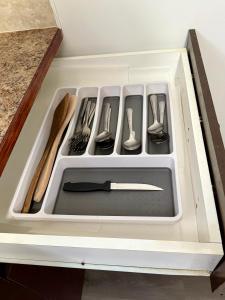 a drawer filled with utensils in a kitchen at Cozy 1-Bed Basement Suite in Calgary