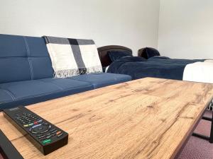 a living room with a blue couch and a wooden coffee table at ドッグランがある宿-ペンション歩野慕野-honobono in Kitashiobara +107 photos