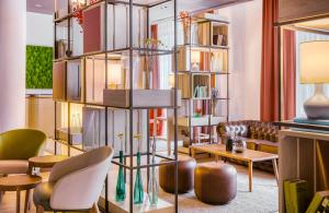 a room with a library with a table and chairs at Hotel Nürnberg City Center by Leonardo Hotels in Nuremberg