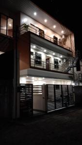 a building with two balconies on top of it at night at Mizpah Apartelle in Tagbilaran City