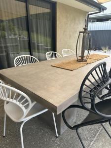 a table with chairs and a lamp on a patio at The Garden Room in Clyde +23 photos