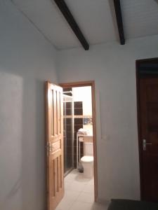 a bathroom with a door leading to a toilet at LE VERDOYANT in Sainte-Anne +59 photos