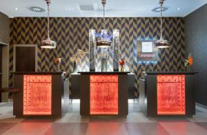 a lobby with two podiums with trophies on it at Leonardo Hotel Dortmund in Dortmund +51 photos