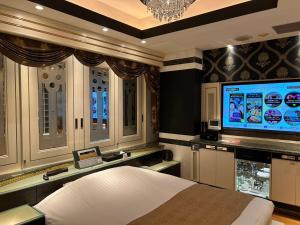 a bedroom with a bed and a flat screen tv at HOTEL PAL Otsuka -Adult Only- in Tokyo