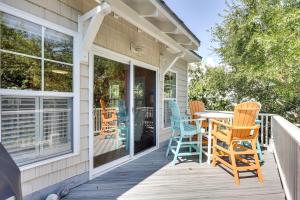 a porch with rocking chairs and a table on it at Happy Hours in Carolina Beach