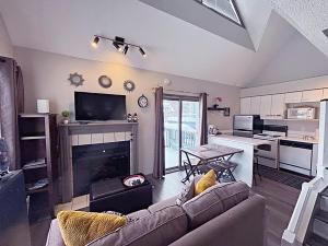 a living room with a couch and a fireplace at Slopeside Loft at North Creek Resort in Blue Mountains