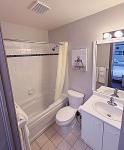 a bathroom with a toilet and a tub and a sink at Slopeside Loft at North Creek Resort in Blue Mountains +20 photos