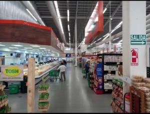 a person standing in a grocery store aisle at Casa Lilia 10 minutos Aeropuerto Tocumen in Panama City