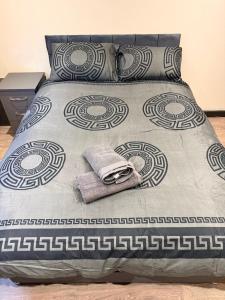 a bed with a pillow and a towel on it at Modern Studios Epsom Station in Epsom