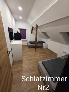 a room with two beds and a staircase at Ferienwohnung NR4 DG Klima in Großräschen