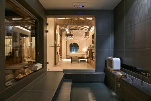 a bathroom with a tv on a counter and a room at Stay Yeojin Yeomong in Gyeongju