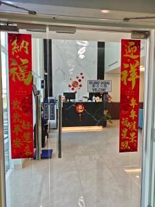 a lobby with red signs on the wall in a building at Yan Hotel in George Town