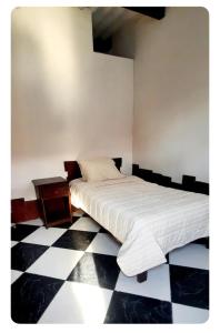 a bedroom with a bed and a checkered floor at Sunset bed in Puerto Chicama