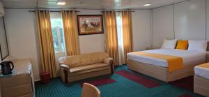 a small bedroom with a bed and a chair at Bhagya Resort Limited in Nikawatawana