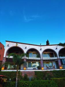 a building with a palm tree in front of it at Suite vista hermosa in San Miguel de Allende