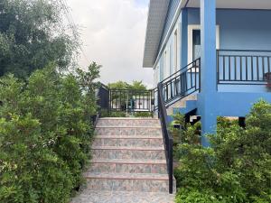 a stairway leading up to a blue building at Very Central Boho Home in Srithanu in Ko Kong Nui