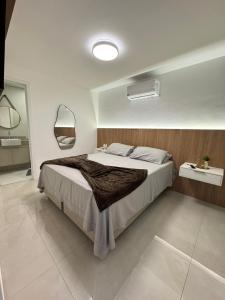 a bedroom with a large bed in a room at Edifício Catamara in Vila Velha