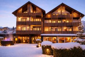 a large building with snow on the ground at Das Kronberg Hotel - Adults Only - inkl Soft- und Heißgetränkeflat in Bodenmais