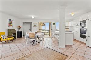 a kitchen and dining room with a table and chairs at Shelly Vista in East Ballina
