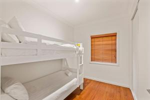 a bedroom with two bunk beds and a window at Shaws View in East Ballina