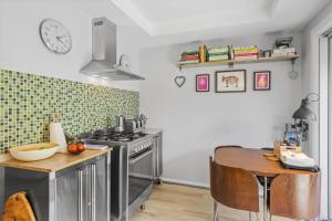 a kitchen with a table and a stove and a counter top at Stingray in Ballina