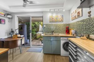 a kitchen with a sink and a washing machine at Stingray in Ballina