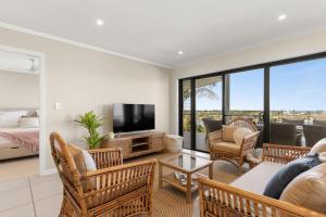 a living room with a couch and a tv at Shawhaven in East Ballina