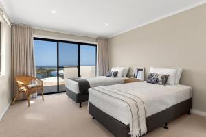 a hotel room with two beds and a large window at Shawhaven in East Ballina