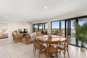 a living room with a table and chairs at Shawhaven in East Ballina