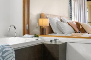 a bathroom with a bed with a large mirror at Shawhaven in East Ballina +19 photos